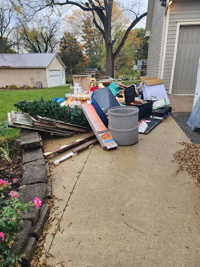 Dumpster being loaded with debris for 12 Yard Dumpster Rental in Conover